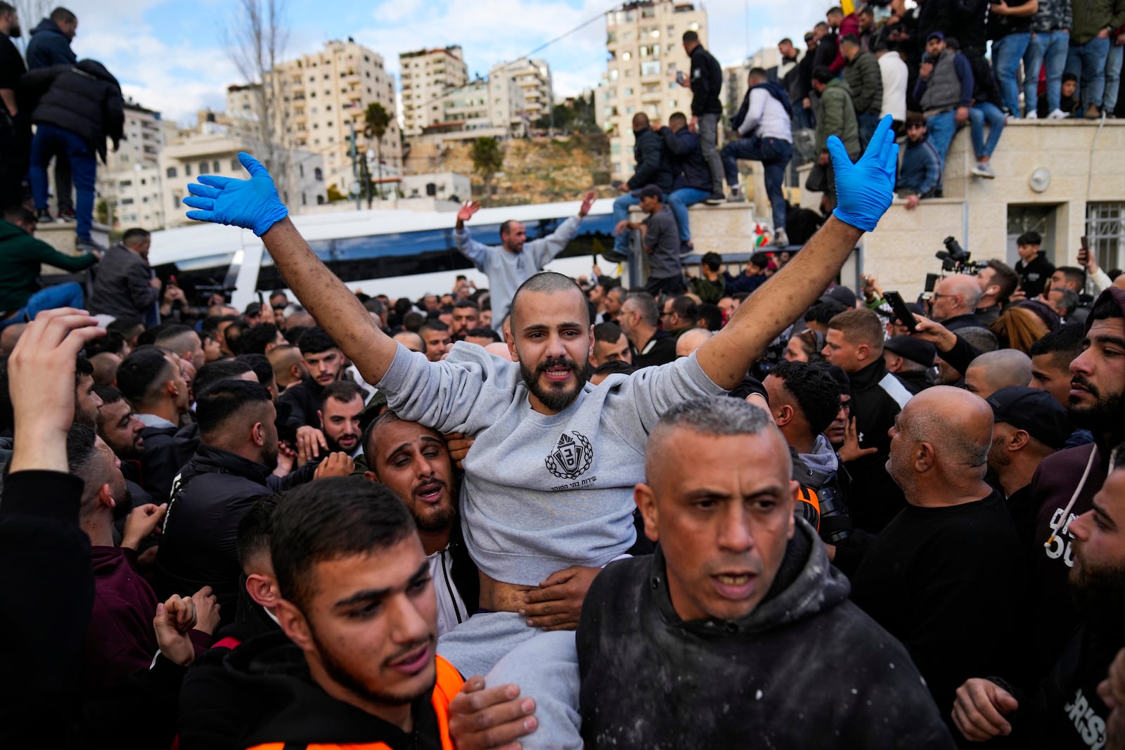 Palestinian prisoners are greeted by a crowd after being released from Israeli prison following a ceasefire agreement with Israel, in the West Bank city of Ramallah, Saturday, Jan. 25, 2025. (AP Photo/Nasser Nasser)