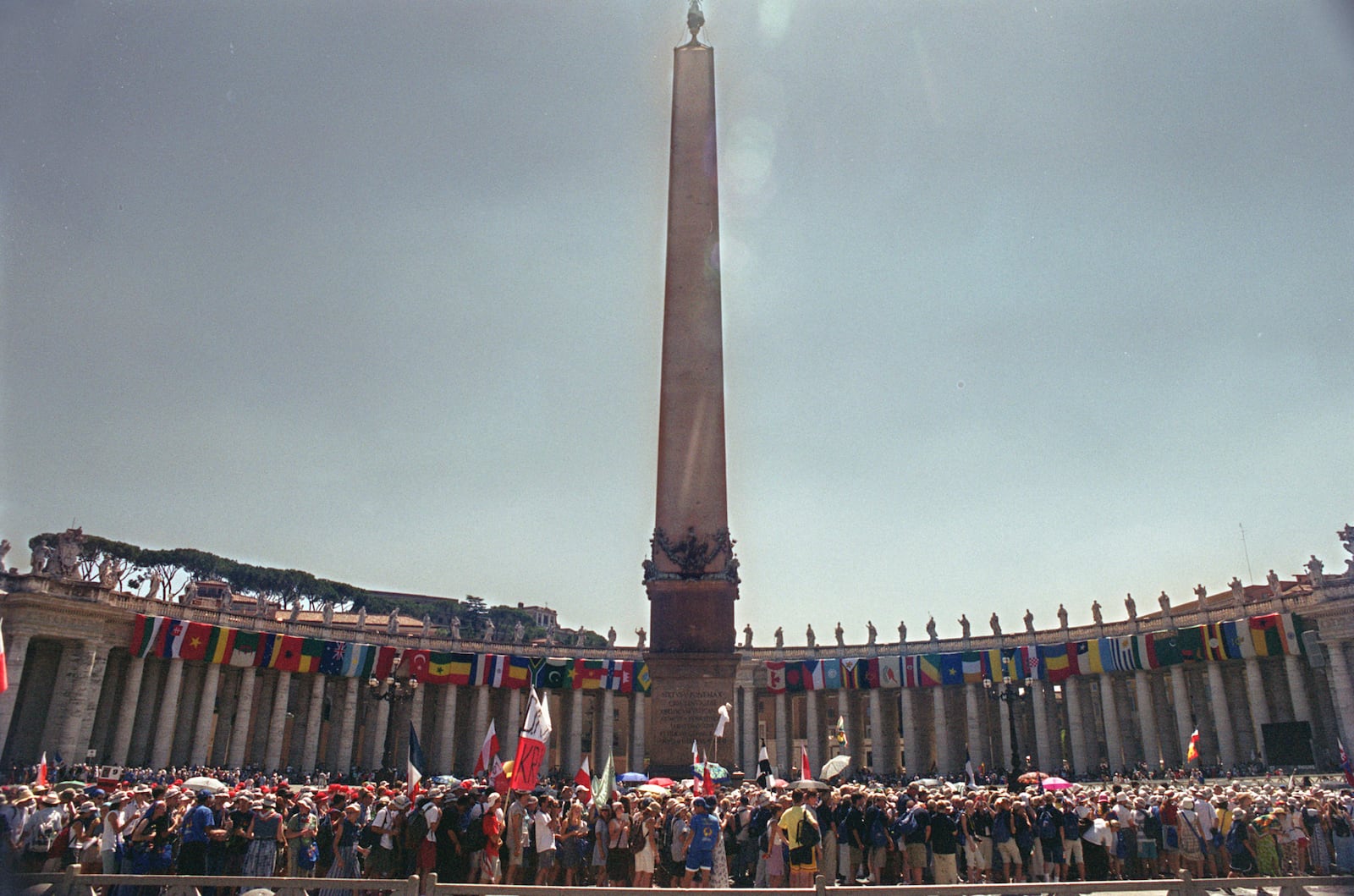 FILE - A view of youths lining up in the middle of St. Peter's Square, to cross the Holy Door inside the Basilica at The Vatican, Wednesday August 16, 2000. (AP Photo/Enric Marti, File)