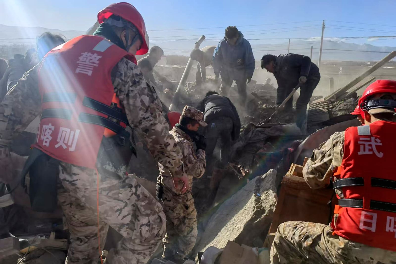 In this photo released by Xinhua News Agency, rescue workers conduct search and rescue for survivors in the aftermath of an earthquake in Changsuo Township of Dingri in Xigaze, southwestern China's Tibet Autonomous Region on Tuesday, Jan. 7, 2025. (Liu Yousheng/Xinhua via AP)