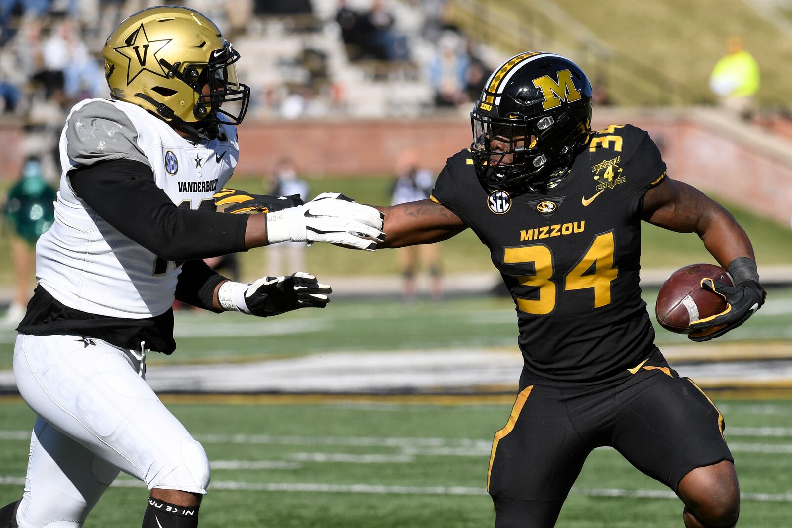 Missouri running back Larry Rountree III (34) runs with the ball as Vanderbilt defensive lineman Dayo Odeyingbo (10) defends during the first half of an NCAA college football game Saturday, Nov. 28, 2020, in Columbia, Mo. (AP Photo/L.G. Patterson)