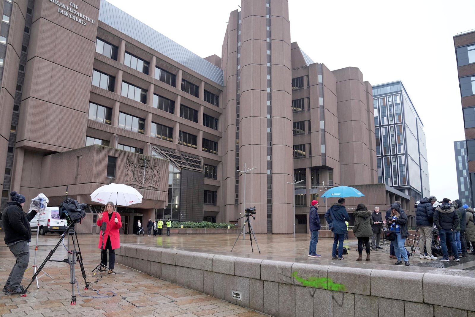 Media waits outside Liverpool Crown Court in Liverpool, England, Monday, Jan. 20, 2025 where Axel Rudakubana is charged with killing three girls and wounding 10 other people in a stabbing rampage at a Taylor Swift-themed dance class in England last summer.(AP Photo/Jon Super)