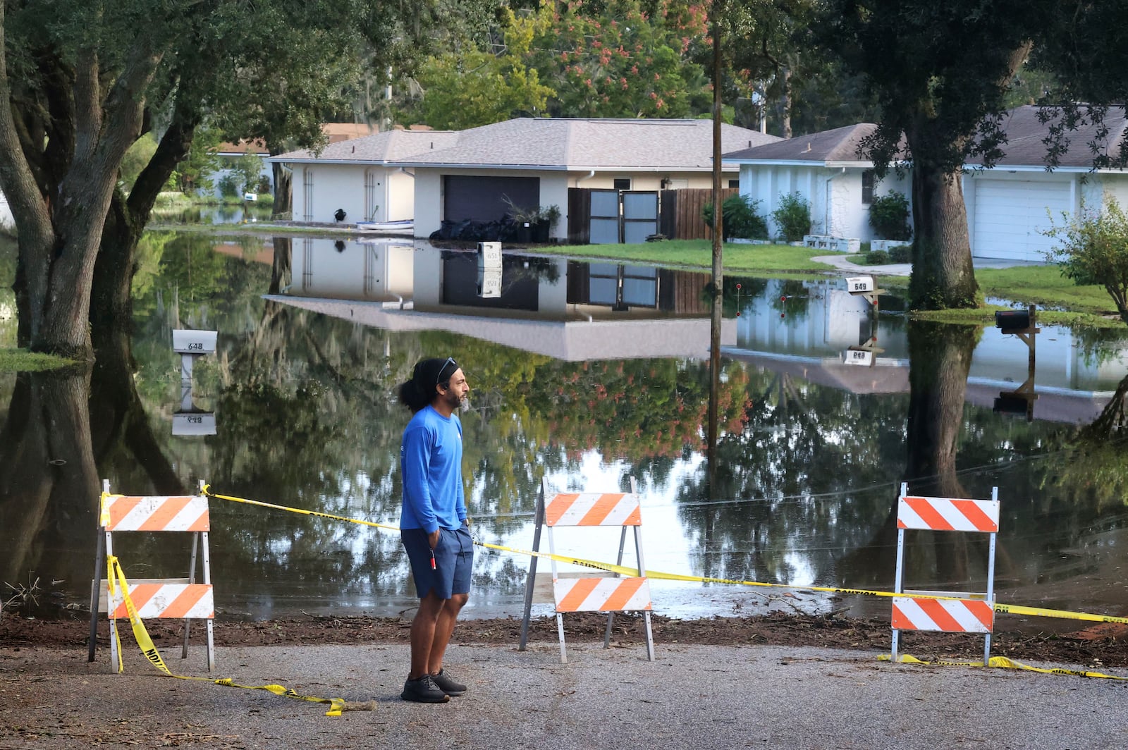 A Spring Oaks resident checks out the rising floodwaters from the Little Wekiva River on Spring Oaks Blvd. in his neighborhood in Altamonte Springs, Fla., Friday, Oct. 11, 2024. Central Florida rivers are forecast to crest in the coming days because of the excessive rainfall from Hurricane Milton. (Joe Burbank/Orlando Sentinel via AP)