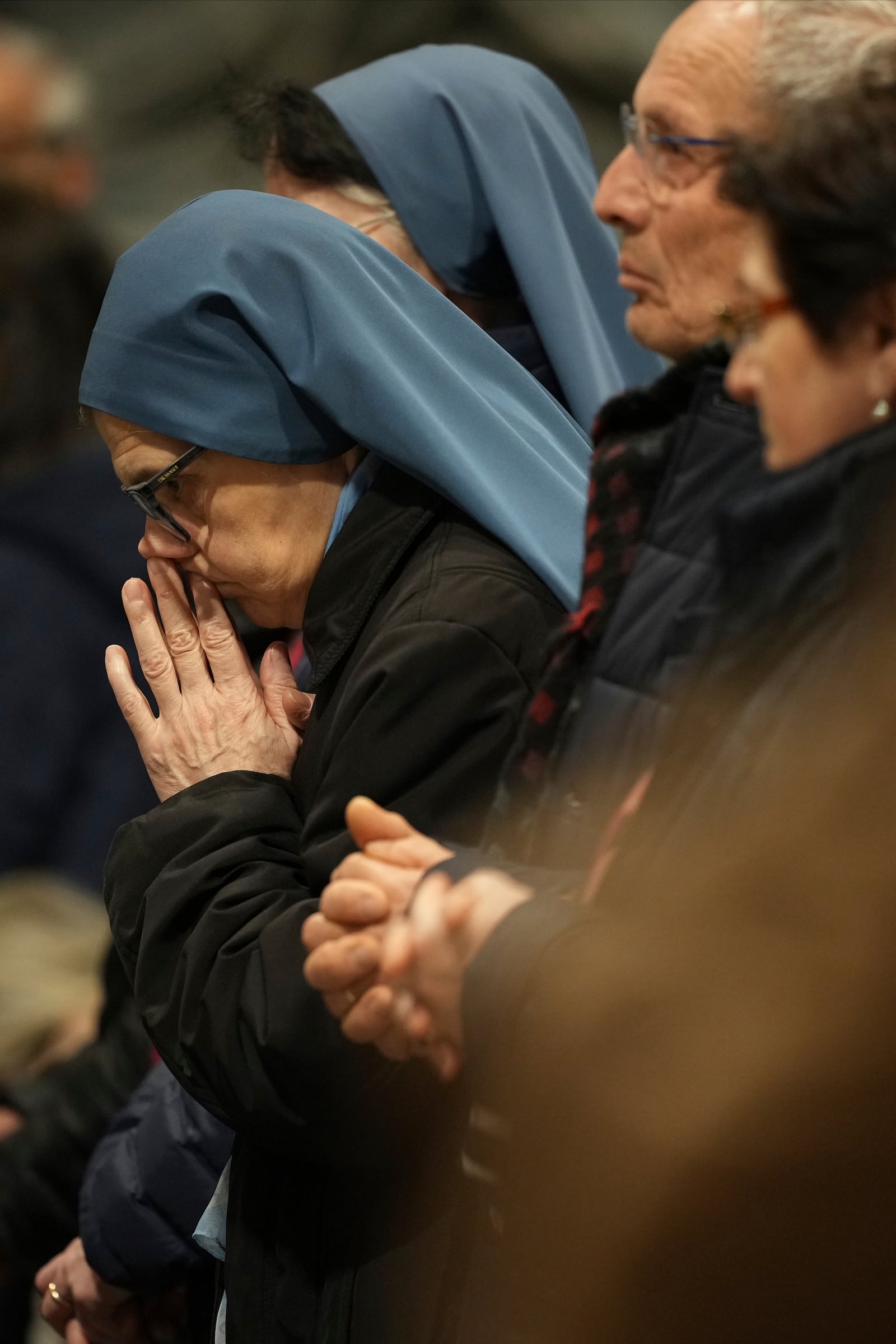 Faithful gather at St. John Lateran Basilica in Rome Sunday, Feb. 23, 2025, to pray for Pope Francis who was admitted over a week ago at Rome's Agostino Gemelli Polyclinic and is in critical condition. (AP Photo/Alessandra Tarantino)