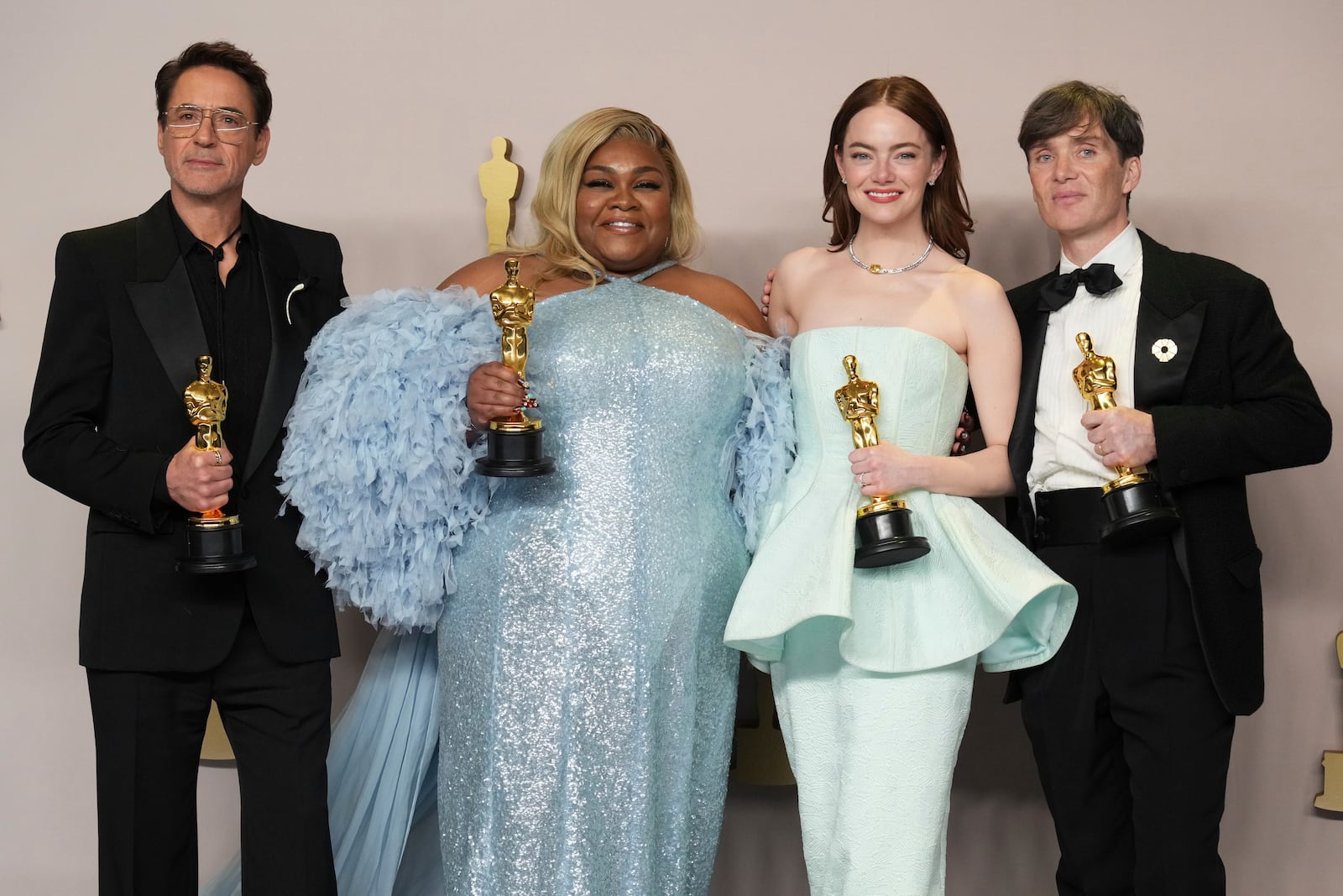 FILE - Oscar winners, from left, Robert Downey Jr., supporting actor for "Oppenheimer," Da'Vine Joy Randolph, supporting actress for "The Holdovers," Emma Stone, lead actress for "Poor Things," and Cillian Murphy, lead actor for "Oppenheimer," pose in the press room at the Oscars in Los Angeles on March 10, 2024. (Photo by Jordan Strauss/Invision/AP, File)