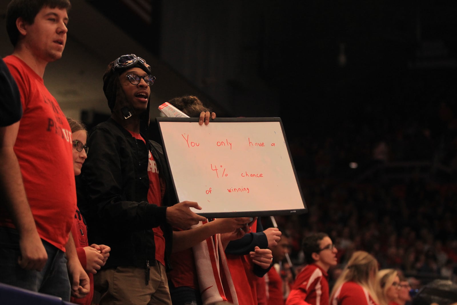 Dayton fan Solomon West holds up a sign in the Red Scare section during a game at UD Arena.