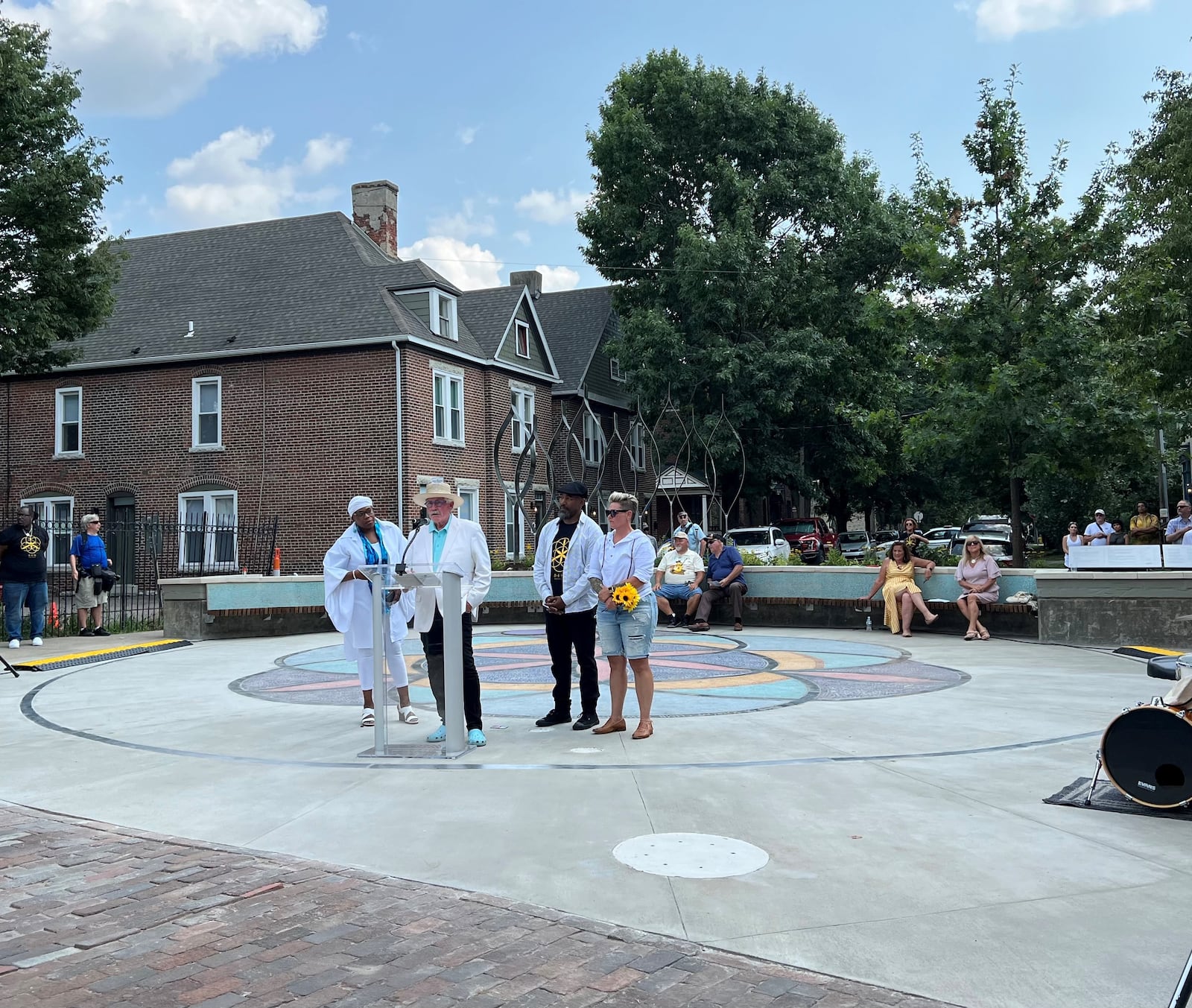 The Seed of Life memorial honoring victims of the 2019 Oregon District shooting was unveiled in Dayton on Aug. 4, 2024. The Seed of Life team that designed and created the memorial include, from left, Sierra Leone, a poet and educator; team leader Terry Welker, an architect and sculptor;  James Pate, an artist and designer and Jes McMillan, an artist from the The Mosaic Institute of Greater Dayton. LYNN HULSEY/STAFF