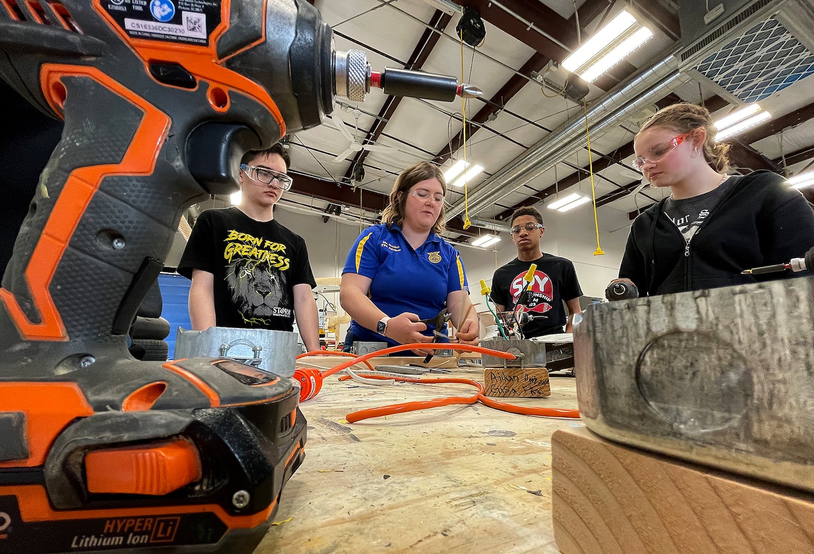 Trisha Seckel, an Ag teacher at the Global Impact STEM Academy, teaches a group of students basic electrical wiring techniques during a class Friday, March 8, 2024. BILL LACKEY/STAFF