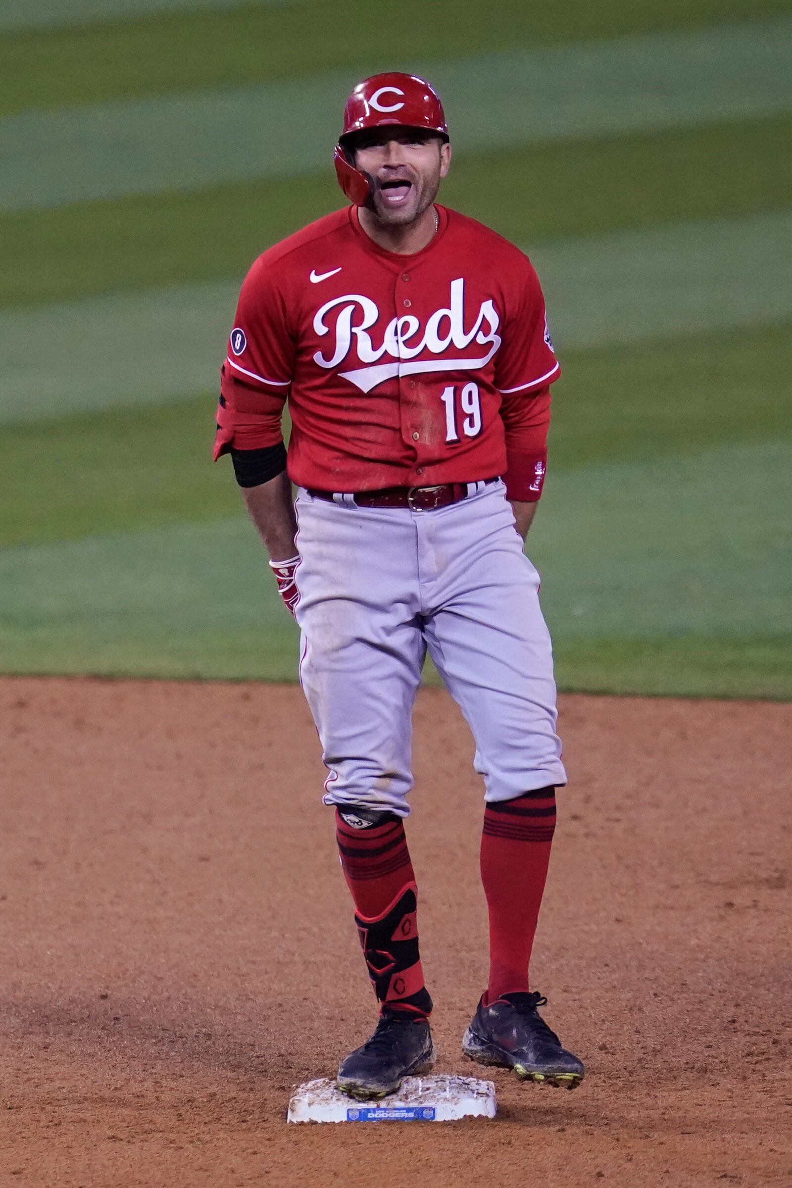 Cincinnati Reds' Joey Votto (19) celebrates after hitting a double during the seventh inning of a baseball game against the Los Angeles Dodgers Tuesday, April 27, 2021, in Los Angeles. Jesse Winkler and Nick Castellanos scored. (AP Photo/Ashley Landis)