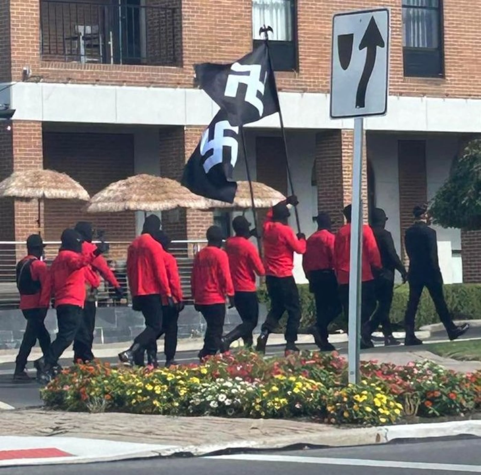 12 people carrying swastika flags and rifles while wearing ski masks walked around downtown Springfield during the Jazz & Blues Fest on Saturday, Aug. 10, 2024. Contributed