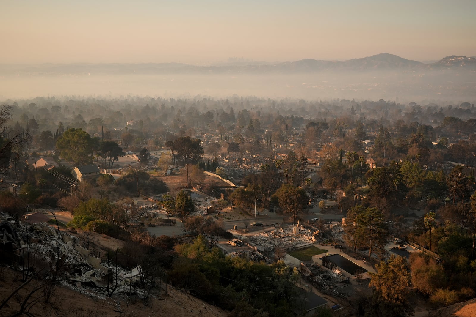 Damage to structures is seen from hilltop perspective in the aftermath of the Eaton Fire Friday, Jan. 10, 2025 in Altadena, Calif. (AP Photo/Jae C. Hong)