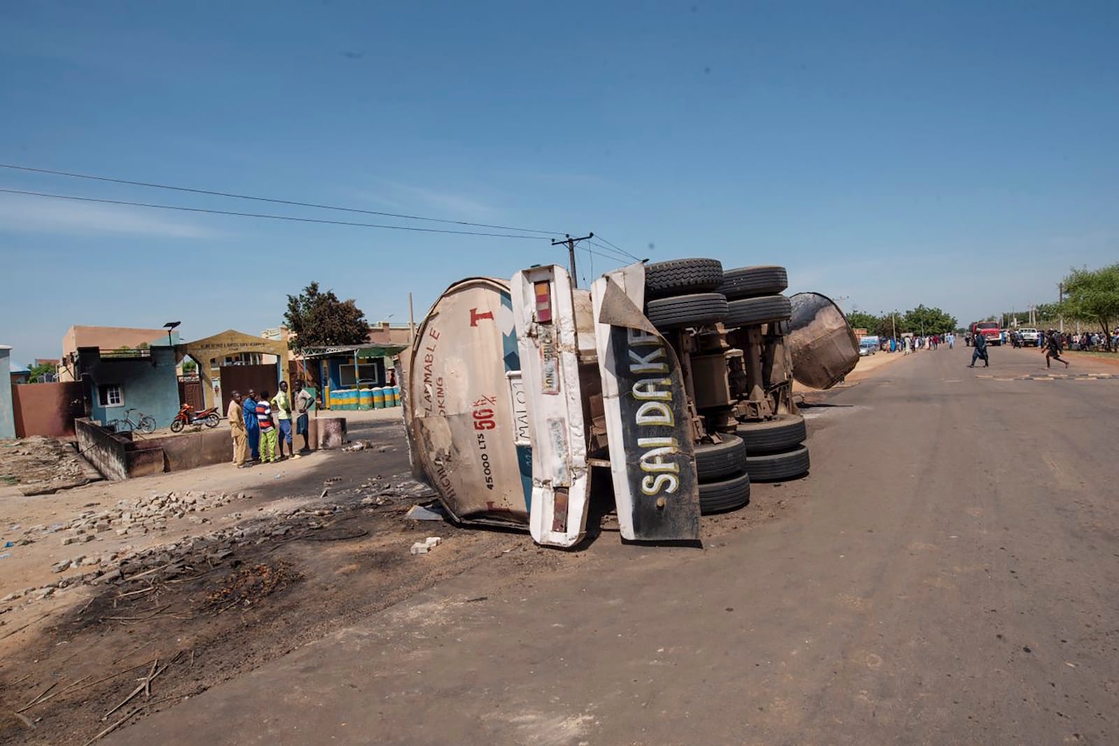 People gather at the scene of a tanker explosion in Majiya town Nigeria, Wednesday, Oct.16, 2024. ( AP Photo/ Sani Maikatanga)