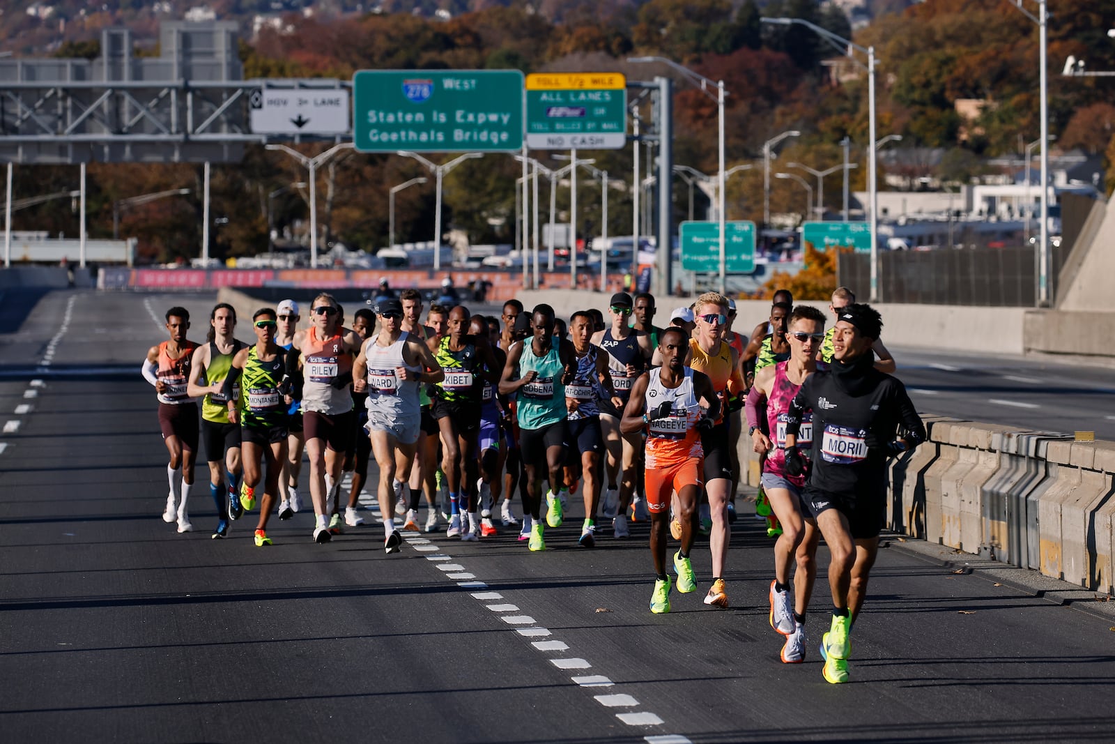 Yuma Morii, right, of Japan, makes his way onto the Verrazzano Narrows bridge with runners in the men's elite division make their way from the start line during the New York City Marathon, Sunday, Nov. 3, 2024, in New York. (AP Photo/Eduardo Munoz Alvarez)