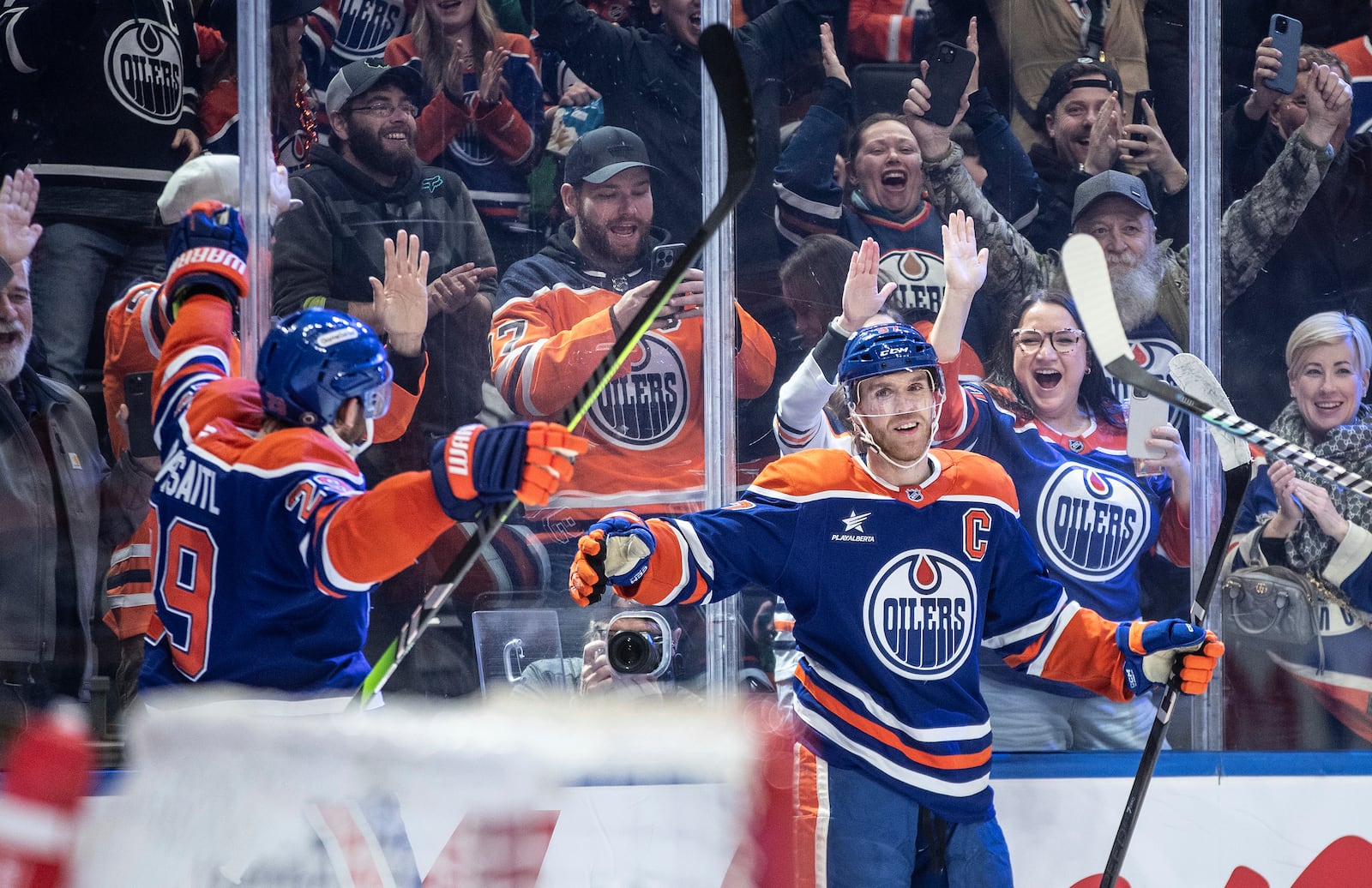 Edmonton Oilers' Connor McDavid (97) celebrates his 1000th point, against the Nashville Predators during the second period of an NHL hockey game, Thursday, Nov. 14, 2024 in Edmonton, Alberta. (Jason Franson/The Canadian Press via AP)