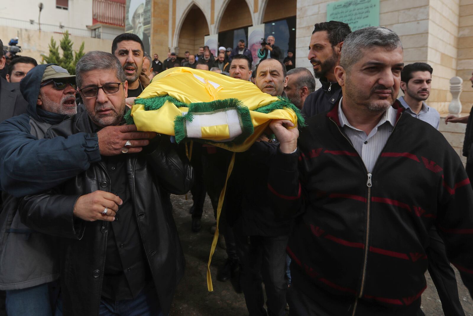 Mourners and relatives of Hezbollah's chief spokesman Mohammed Afif who was killed in an Israeli airstrike in Beirut on Sunday, carry his body during his funeral in the southern port city of Sidon, Lebanon, Monday, Nov. 18, 2024. (AP Photo/Mohammed Zaatari)