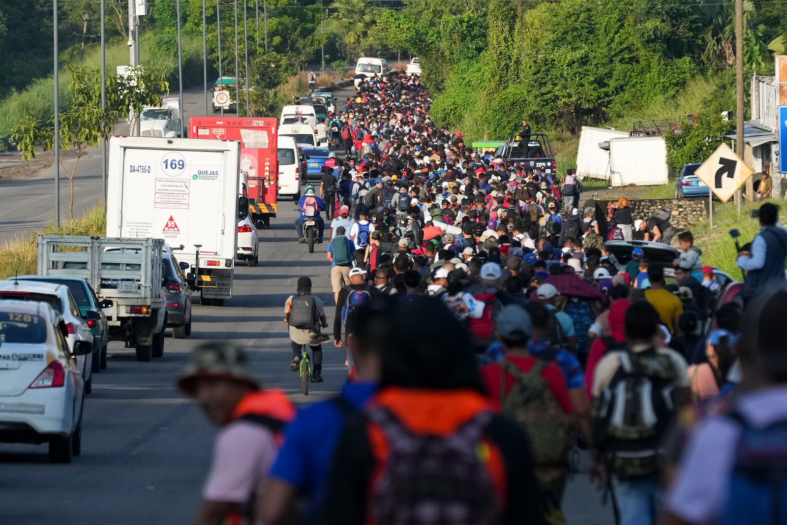 Migrants walk along the Huixtla highway after departing Tapachula, southern Mexico, hoping to reach the country's northern border and ultimately the United States, Tuesday, Nov. 5, 2024. (AP Photo/Moises Castillo)