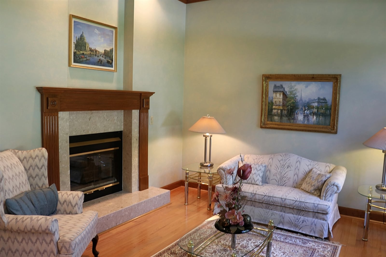 The living room has a dual-sided fireplace with marble surround and hearth. 