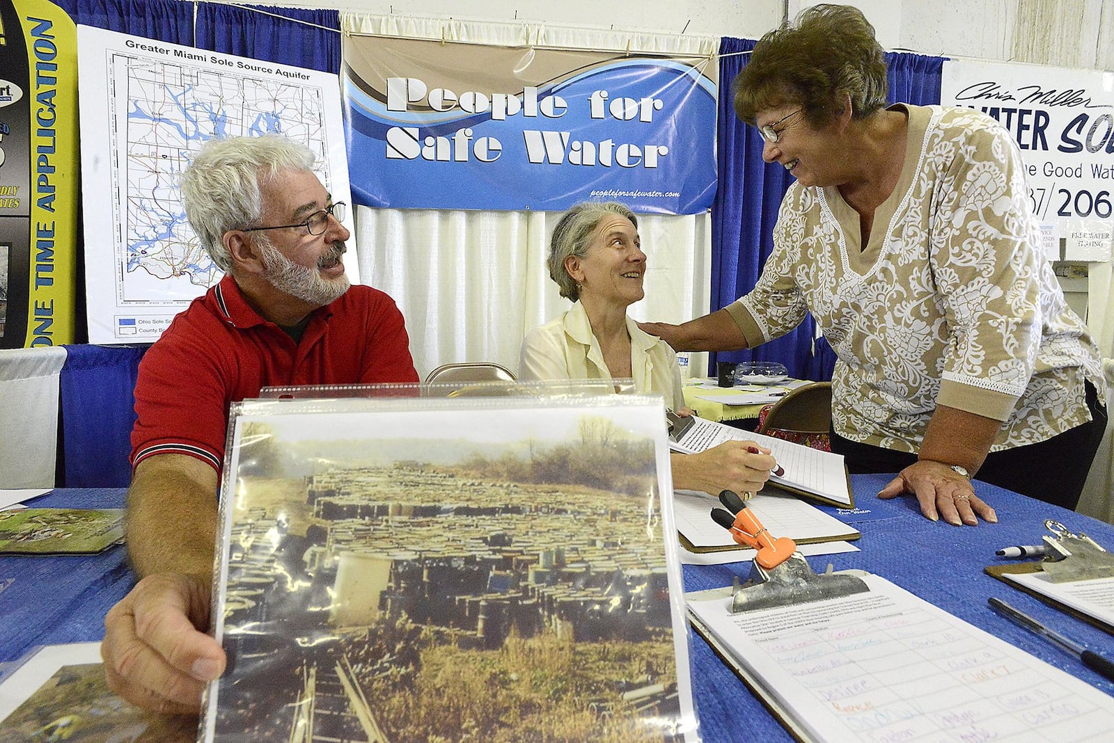 This 2015 file photo shows rom left, Larry Ricketts, Jeannie Ricketts and Laura Kaffenbarger manning the  People For Safe Water booth at the Clark County Fair. BILL LACKEY/STAFF