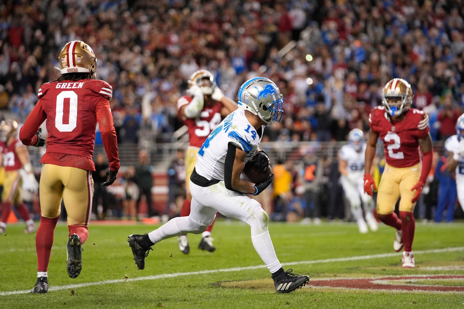 Detroit Lions wide receiver Amon-Ra St. Brown (14) catches a touchdown during the second half of an NFL football game against the San Francisco 49ers, Monday, Dec. 30, 2024, in Santa Clara, Calif. (AP Photo/Godofredo A. Vásquez)