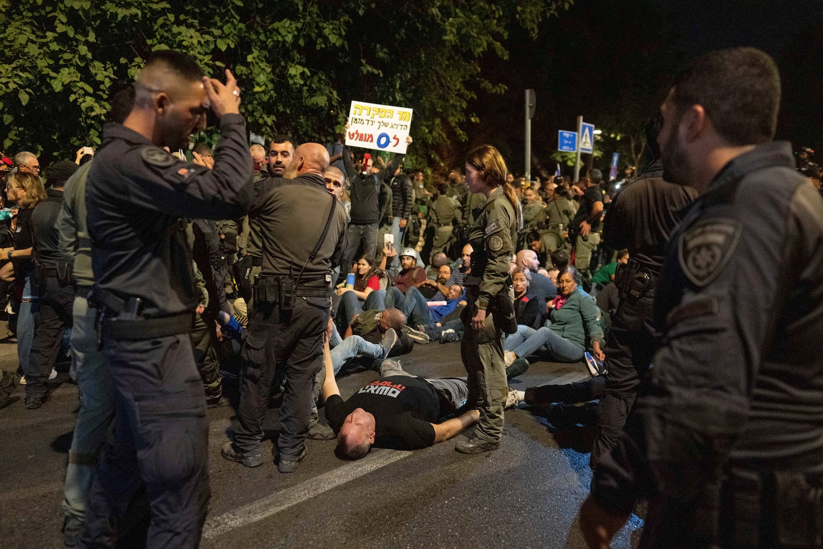 Police disperse people protesting against Prime Minister Benjamin Netanyahu's government and calling for the release of hostages held in the Gaza Strip by the Hamas militant group, near the Prime Minister's residence in Jerusalem, Monday, Oct. 28, 2024. (AP Photo/Ohad Zwigenberg)