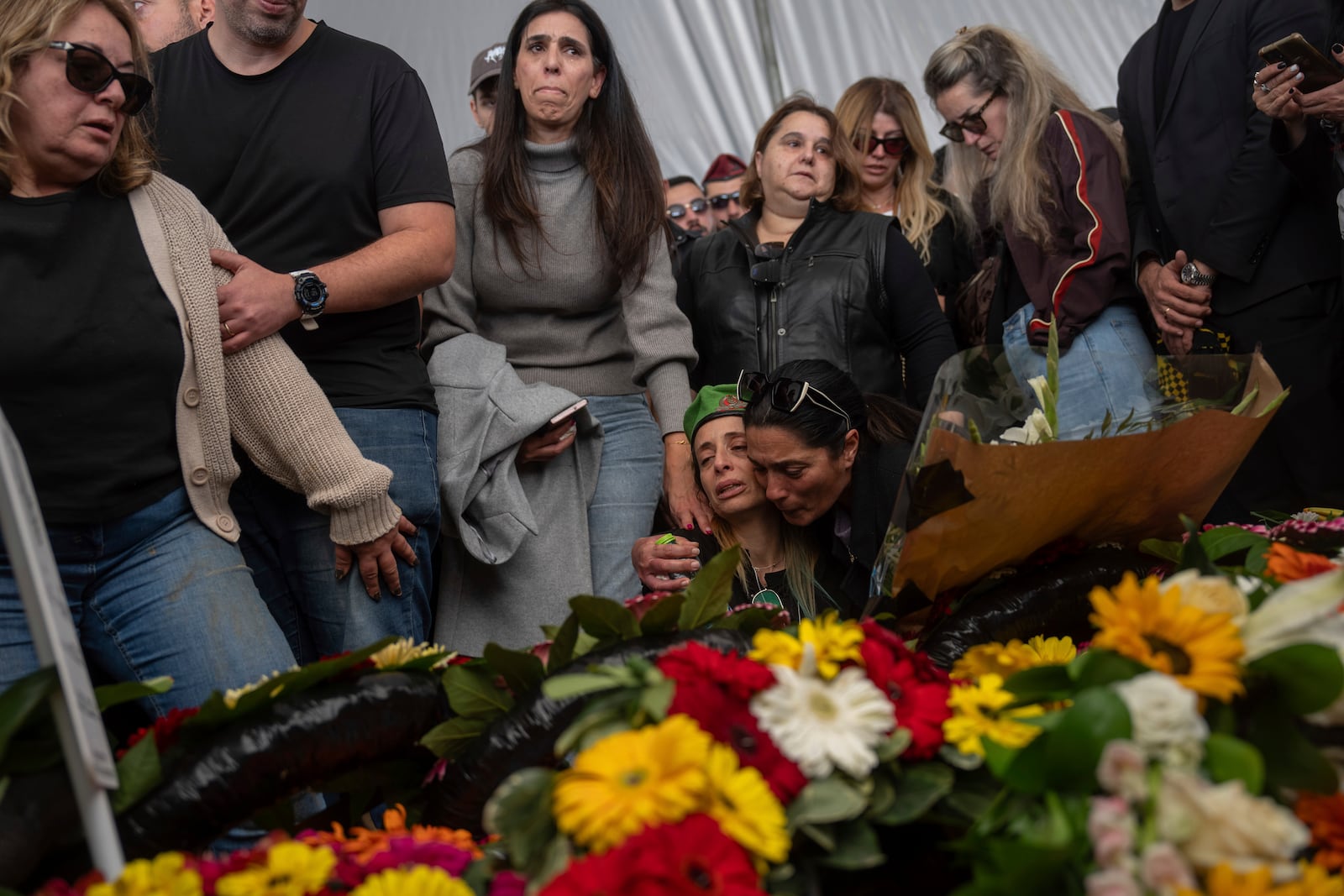 Gali the mother of the Israeli soldier Sergeant Yahav Maayan who was killed in combat in the Gaza Strip, reacts next to his son's grave during his funeral at a military cemetery in Modiin, Israel, Sunday, Jan. 12, 2025. (AP Photo/Ohad Zwigenberg)