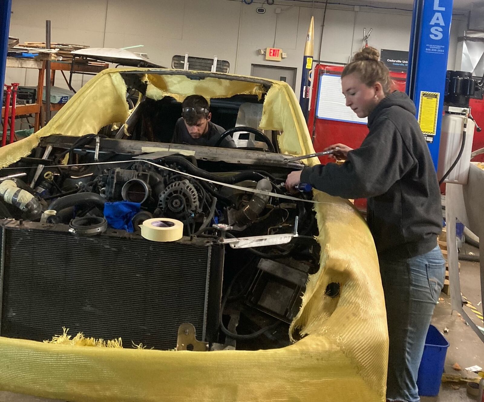 John Thomson (in the car) and Kennedy Southland continue working on their race car in preparation for the Grassroots competition. | CONTRIBUTED