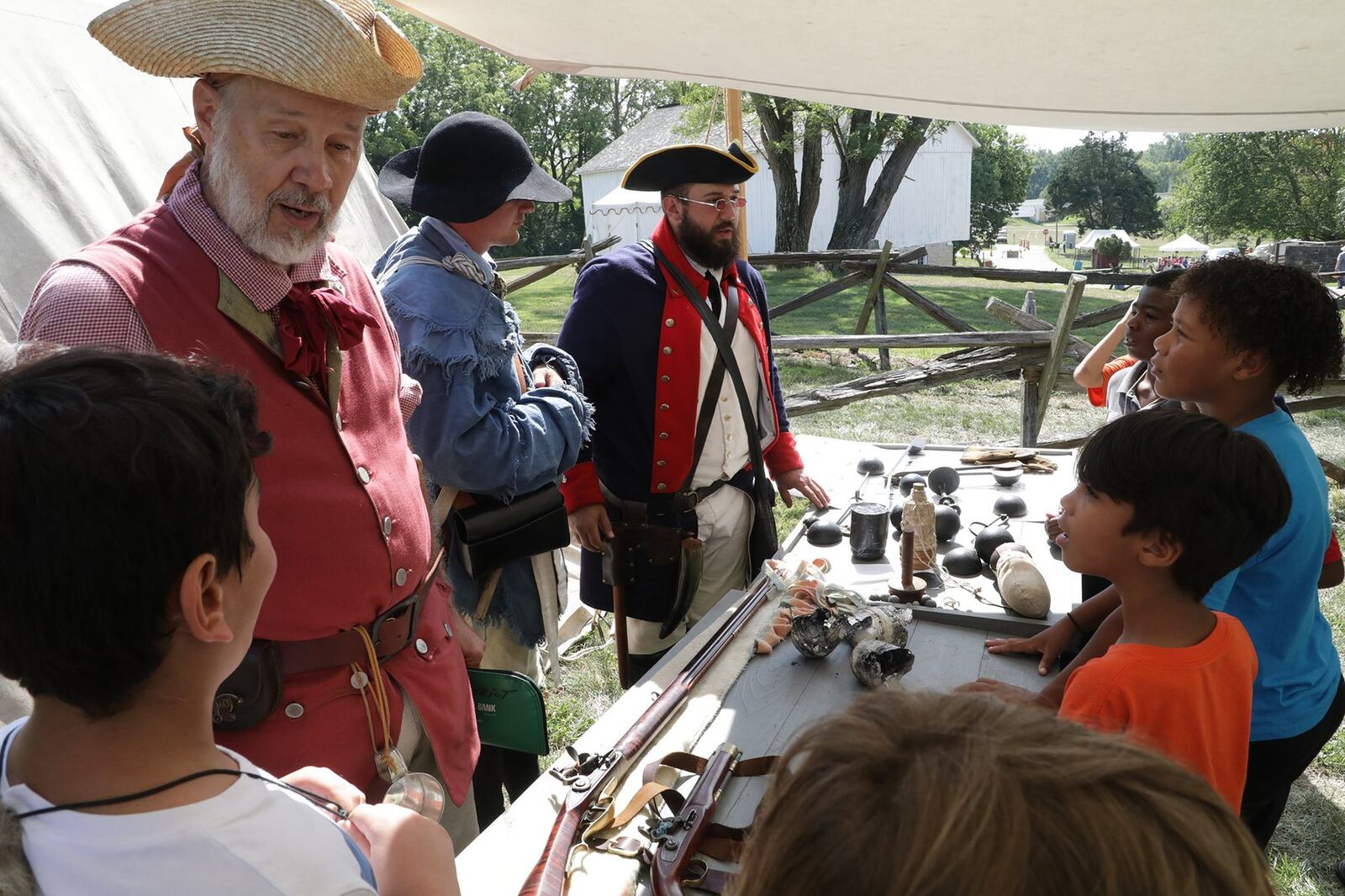 Students learn about military weapons and tactics in the 18th century during Education Day at the Fair at New Boston last year. This year's festival has been canceled. BILL LACKEY/STAFF