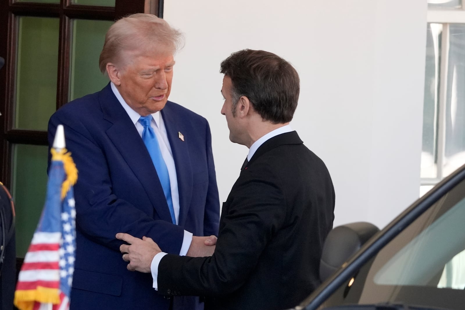 President Donald Trump, left, greets France's President Emmanuel Macron before a news conference at the White House, Monday, Feb. 24, 2025, in Washington. (AP Photo/Manuel Balce Ceneta)