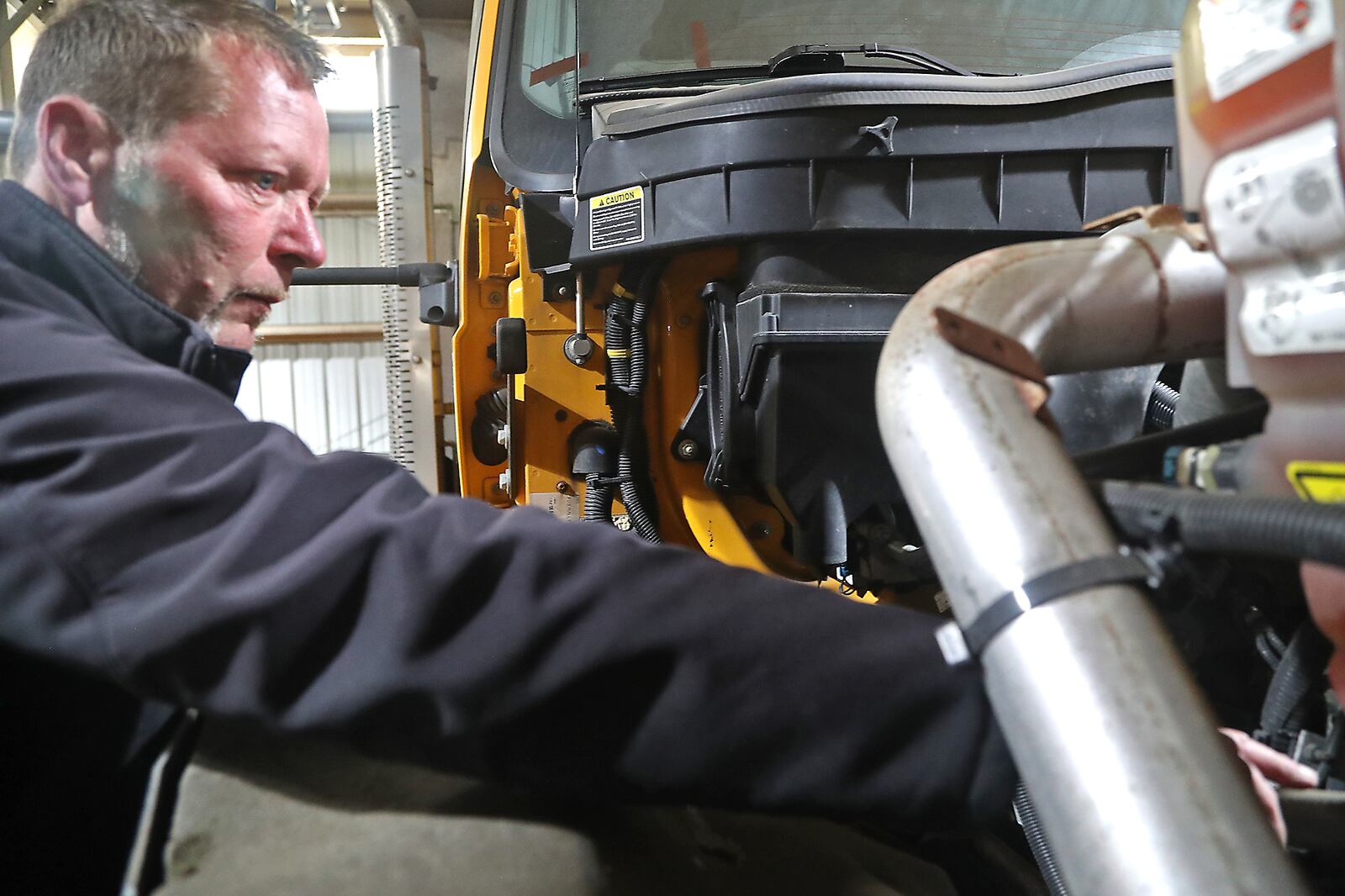 Eric Erter, Springfield Public Works Superintendent, checks something under the hood of one of the city's plow trucks Monday, Oct. 17, 2022. The City of Springfield has been busy attaching blades and making sure their fleet of truck are ready for winter. BILL LACKEY/STAFF