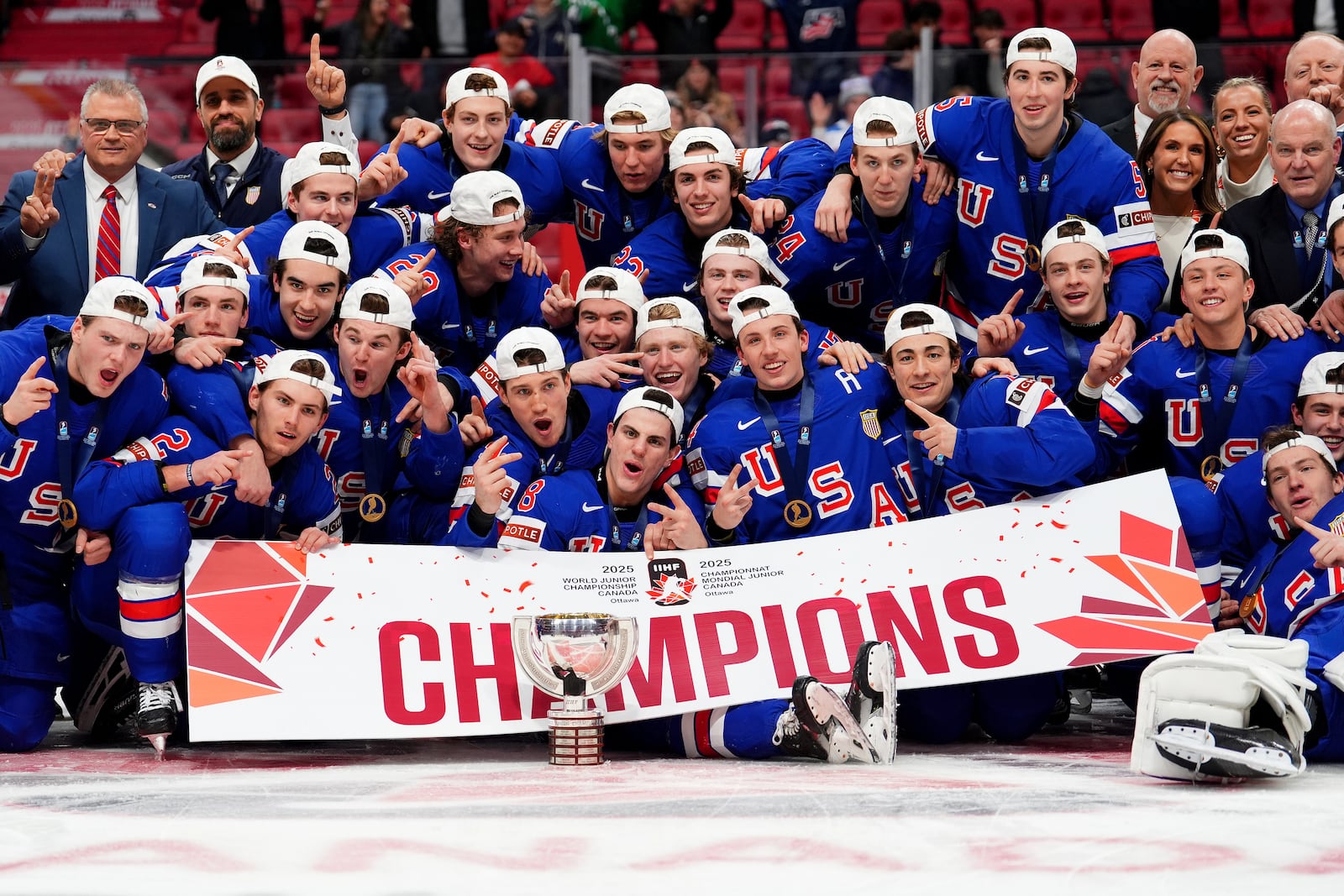 United States players pose for a group photo with the trophy following the IIHF World Junior Hockey Championship gold medal game win over Finland, in Ottawa, Ontario, Sunday, Jan. 5, 2025. (Sean Kilpatrick/The Canadian Press via AP)