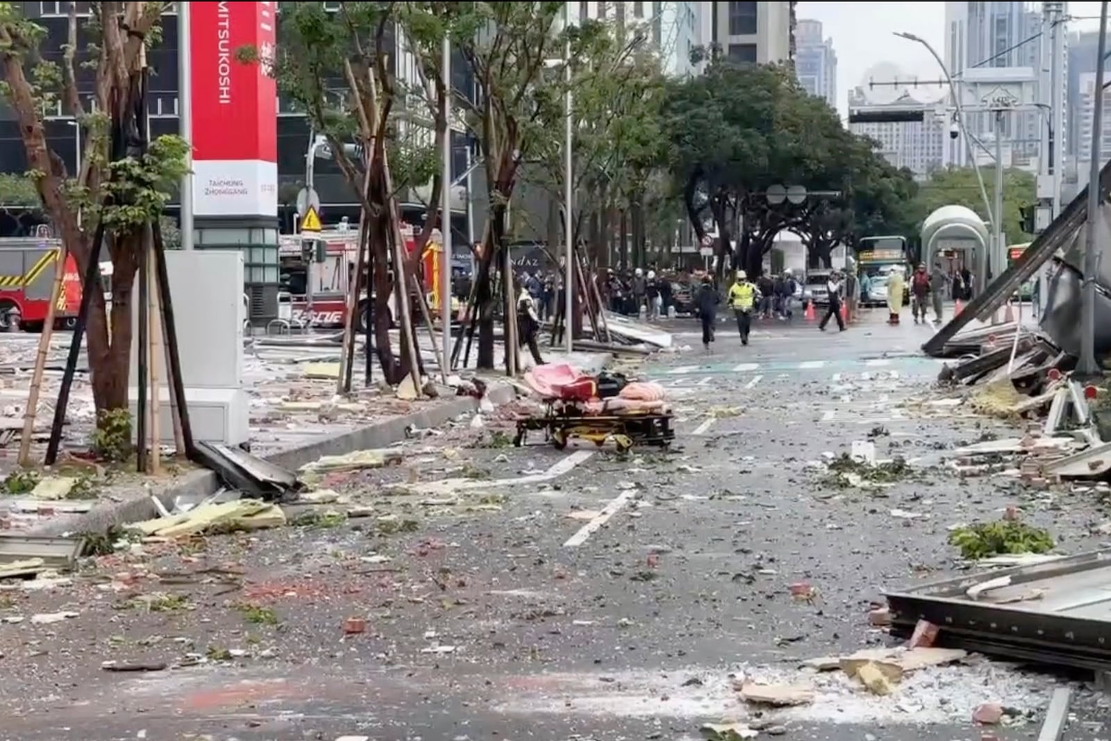 This image taken from video by Taiwan's TVBS shows the debris are strewn across the streets in the aftermath of an explosion at the Shin Kong Mitsukoshi department store in Taichung city in Taiwan on Thursday, Feb. 13, 2025. (TVBS via AP )