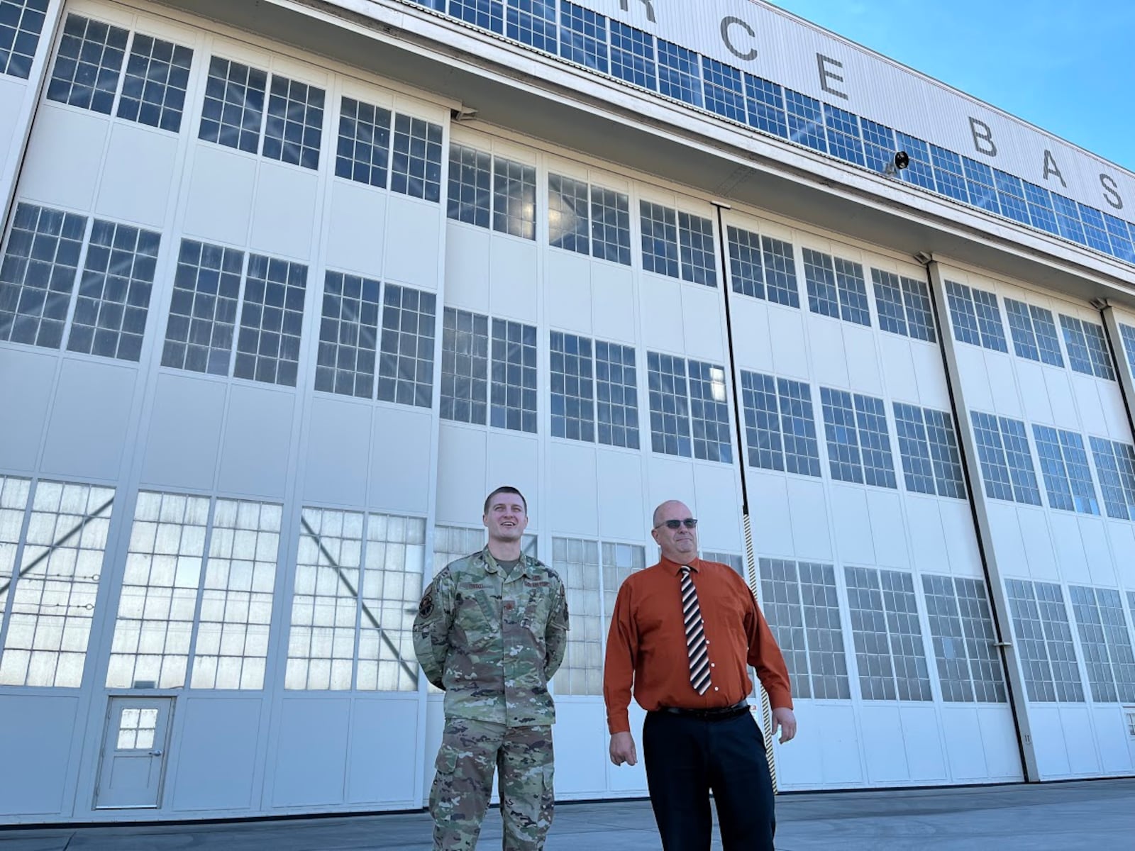 Maj. Hollis Troxel, director of operations for the 88th Operations Support Squadron at Wright-Patterson Air Force Base (left), and Thomas Riste, director 88th Logistics Readiness Squadron, also at Wright-Patt, on the base flight line Tuesday. THOMAS GNAU/STAFF 