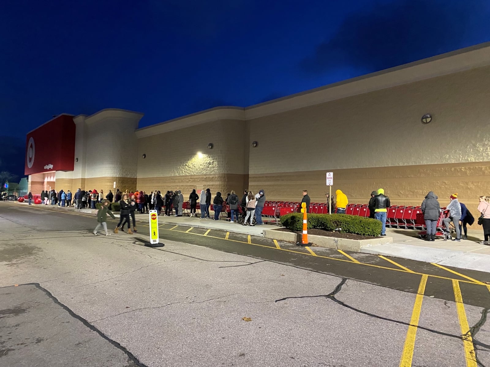 Around 100 people stood in line at the Beavercreek Target, with more in their cars. | EILEEN MCCLORY \ STAFF