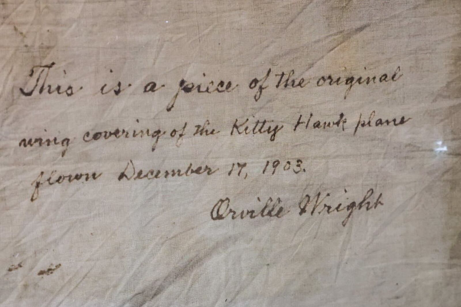 In building 5 on Wright-Patterson Air Force Base's Area B is the home of the museum's artifacts including autographed swath of cloth from the original 1903 Wright Flyer. JIM NOELKER/STAFF
