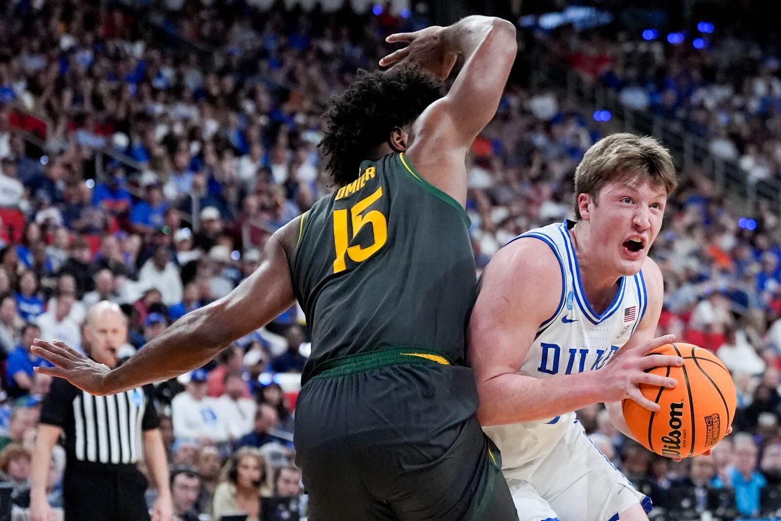 Duke guard Kon Knueppel drives to the basket past Baylor forward Norchad Omier during the first half in the second round of the NCAA college basketball tournament, Sunday, March 23, 2025, in Raleigh, N.C. (AP Photo/Chris Carlson)