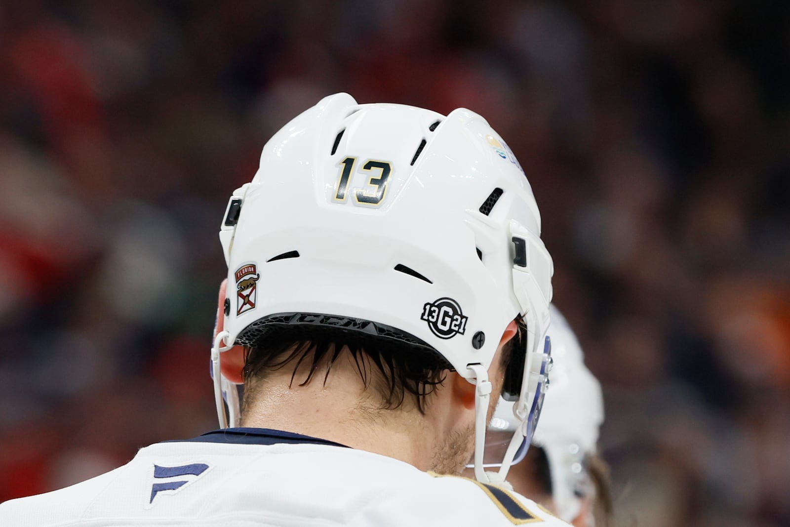 Florida Panthers players, including Sam Reinhart, wear helmet stickers honoring Johnny Gaudreau and his brother Matthew during the first period of an NHL hockey game against the Columbus Blue Jackets Tuesday, Oct. 15, 2024, in Columbus, Ohio. All teams in the NHL will wear helmet stickers honoring the Gaudreau brothers. (AP Photo/Jay LaPrete)