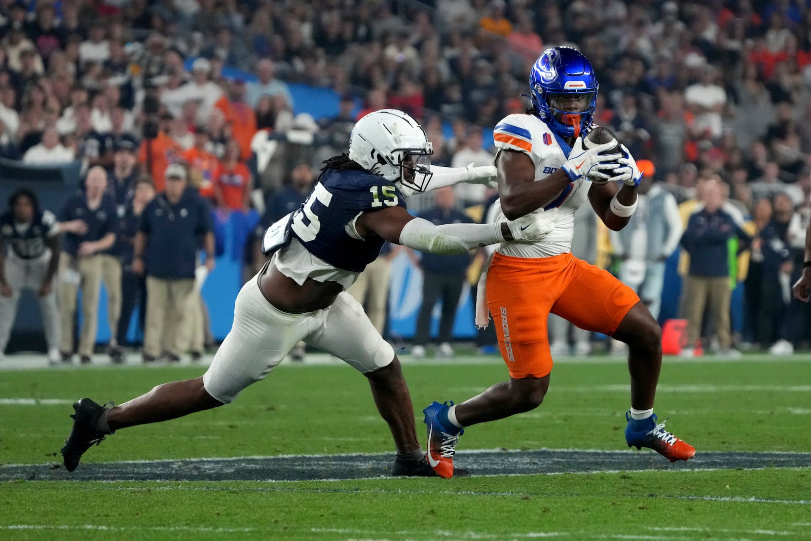 Penn State defensive end Amin Vanover (15) tackles Boise State running back Jambres Dubar (1) during the first half of the Fiesta Bowl NCAA college football CFP quarterfinal game, Tuesday, Dec. 31, 2024, in Glendale, Ariz. (AP Photo/Rick Scuteri)