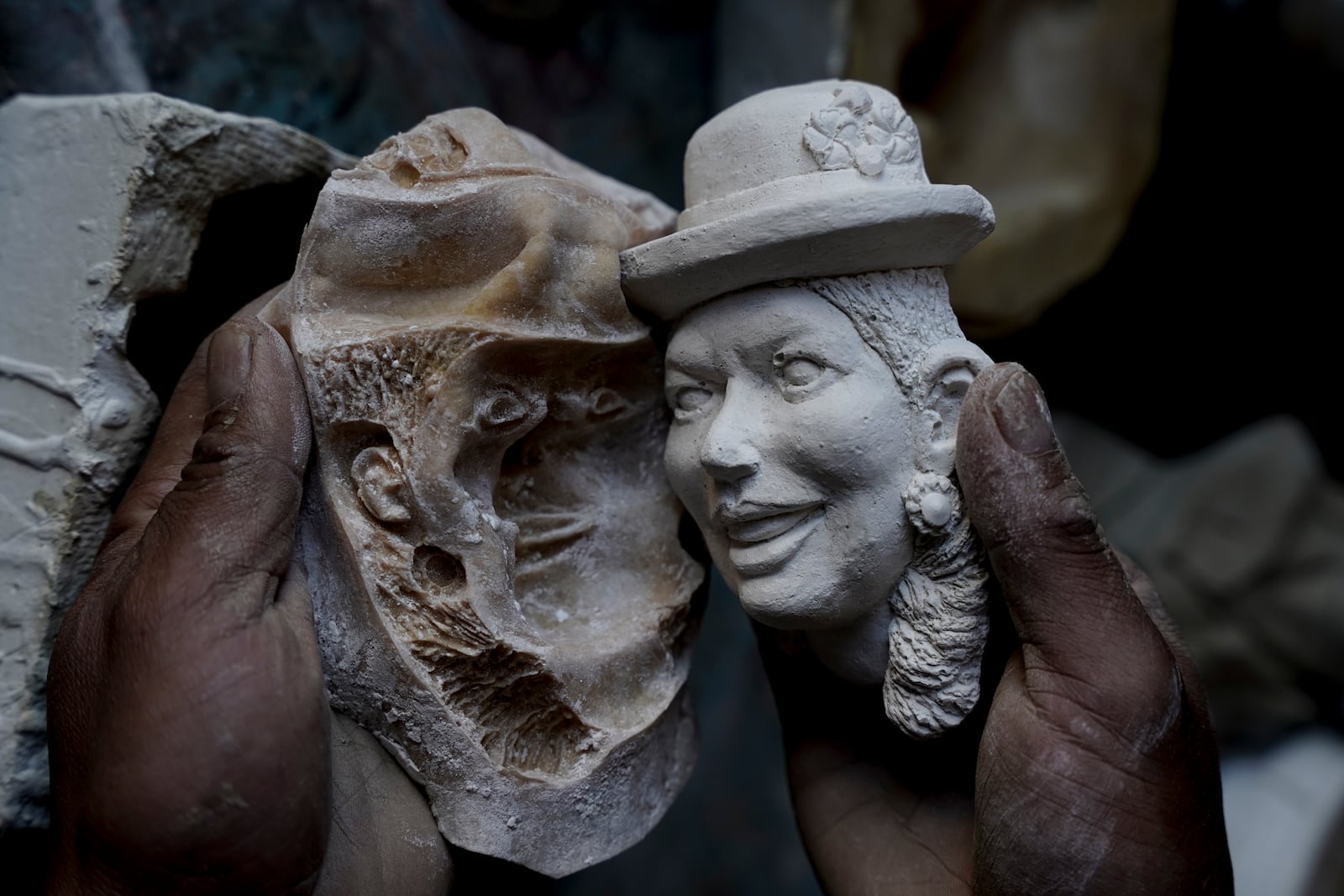 Artisan William Luna creates a mask as Bolivia celebrates the Day of the Dead with tantawawa bread adorned with plaster masks of loved ones' faces in La Paz, Bolivia, Thursday, Oct. 31, 2024. (AP Photo/Freddy Barragan)