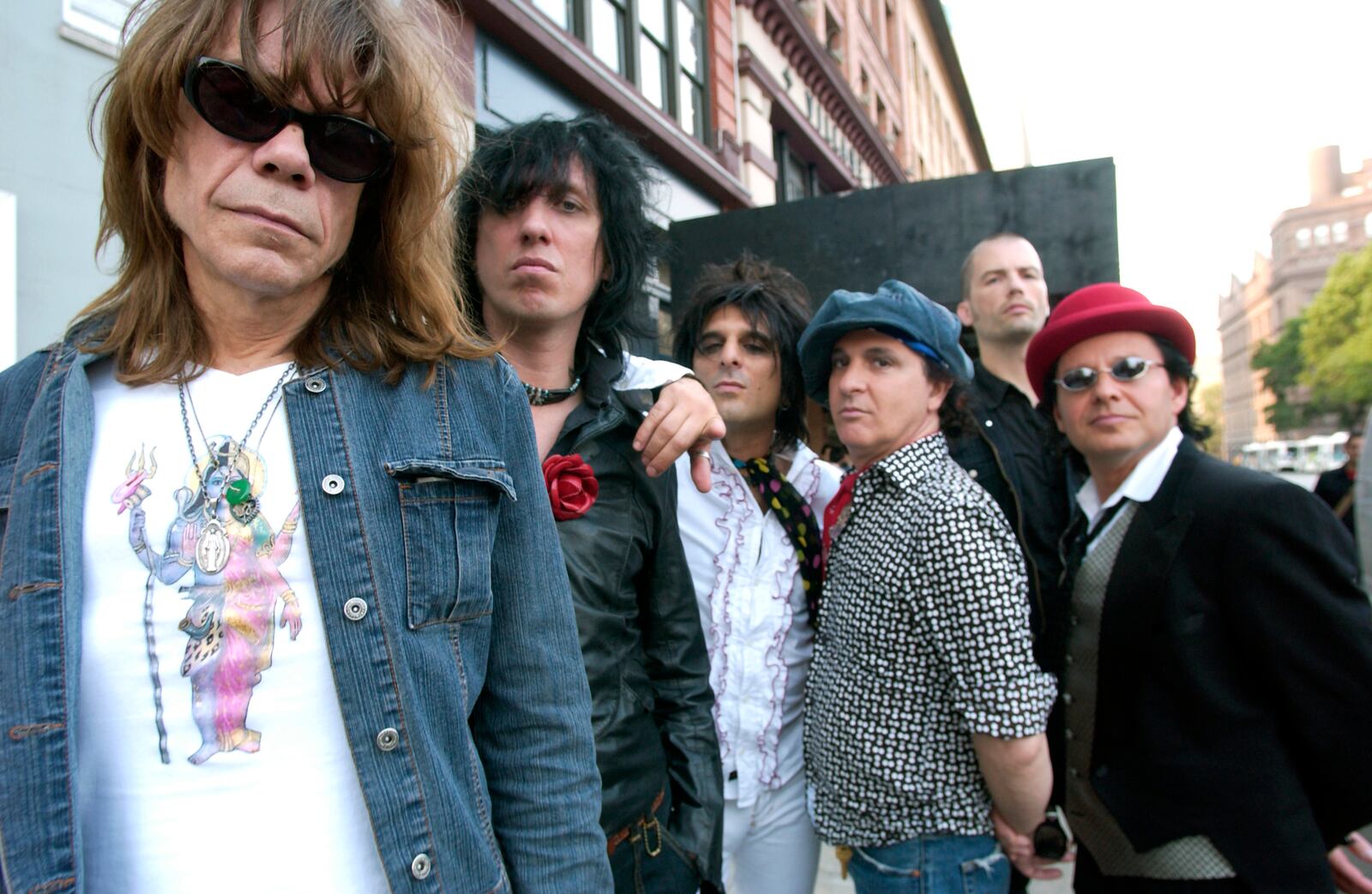 FILE - The New York Dolls are photographed in New York, July 25, 2006. From left are David Johansen, Sami Yaffa, Steve Conte, Sylvain Sylvain, Brian Delaney, rear, and Brian Koonin. (AP Photo/Jim Cooper, File)