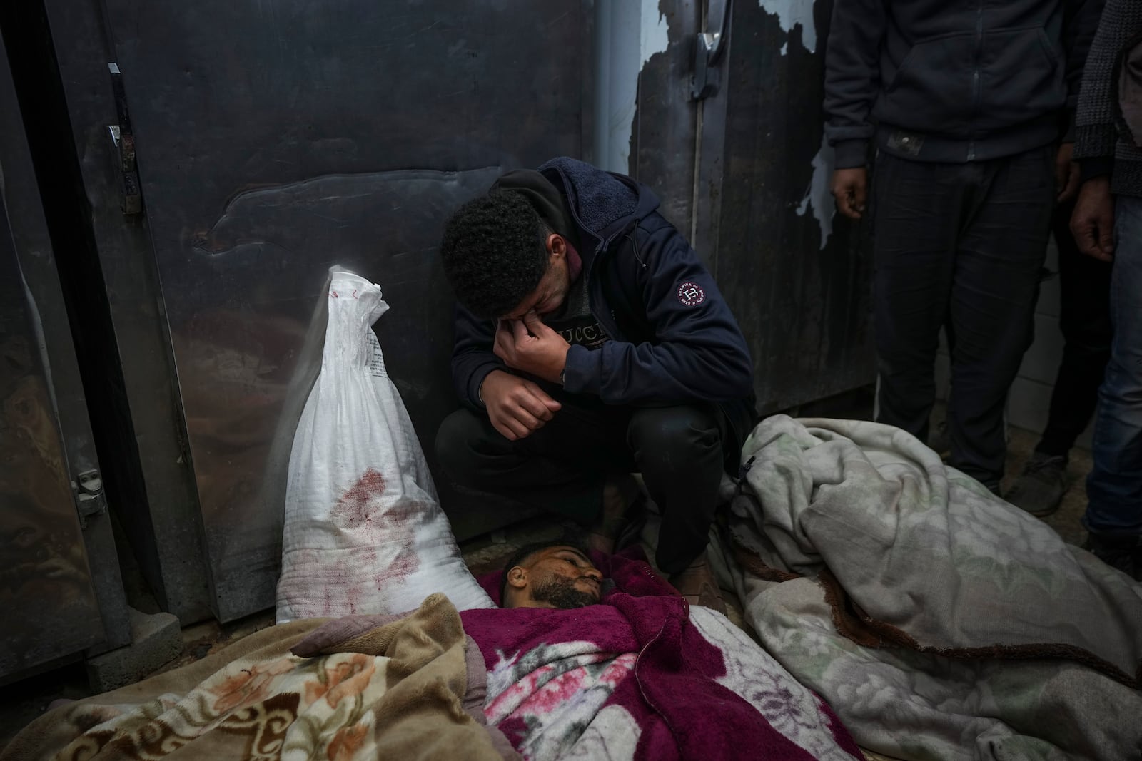 Kareem Al-Dabaji mourns his brother Anas Al-Dabaji, who was killed in an Israeli airstrike that hit an apartment in Deir Al-Balah, at Al-Aqsa Hospital morgue in Deir Al-Balah, Gaza, Thursday, Jan. 9, 2025. (AP Photo/Abdel Kareem Hana)