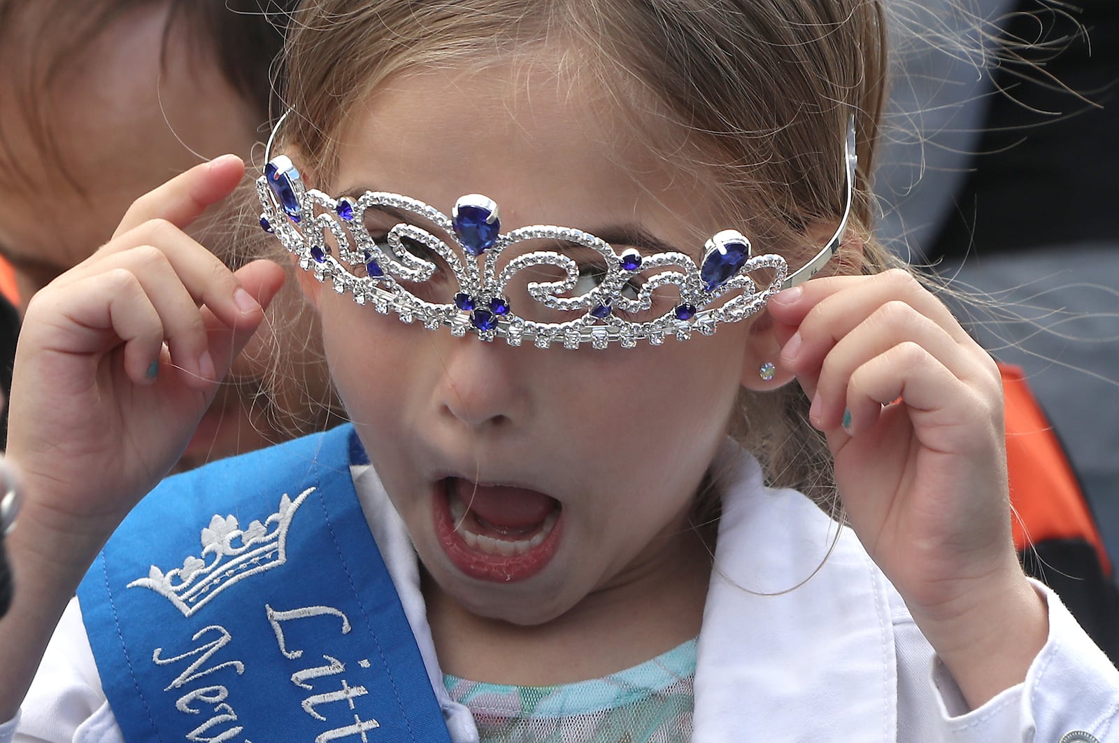 Emalline Daugherty, 7, reacts as her crown keeps falling down over her eyes Saturday, Oct. 1, 2022, after she was crowned Little Miss Heritage of Flight at the Heritage of Flight Festival in New Carlisle. The image was one of six Springfield News-Sun photographer Bill Lackey submitted to the Ohio Society of Professional Journalists to earn Ohio Photographer of the Year, an award announced Monday. BILL LACKEY/STAFF