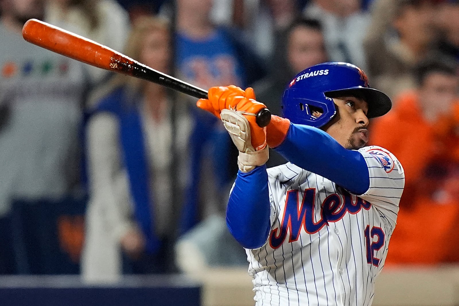 New York Mets' Francisco Lindor (12) follows through on a grand slam home run against the Philadelphia Phillies during the sixth inning of Game 4 of the National League baseball playoff series, Wednesday, Oct. 9, 2024, in New York. (AP Photo/Frank Franklin II)