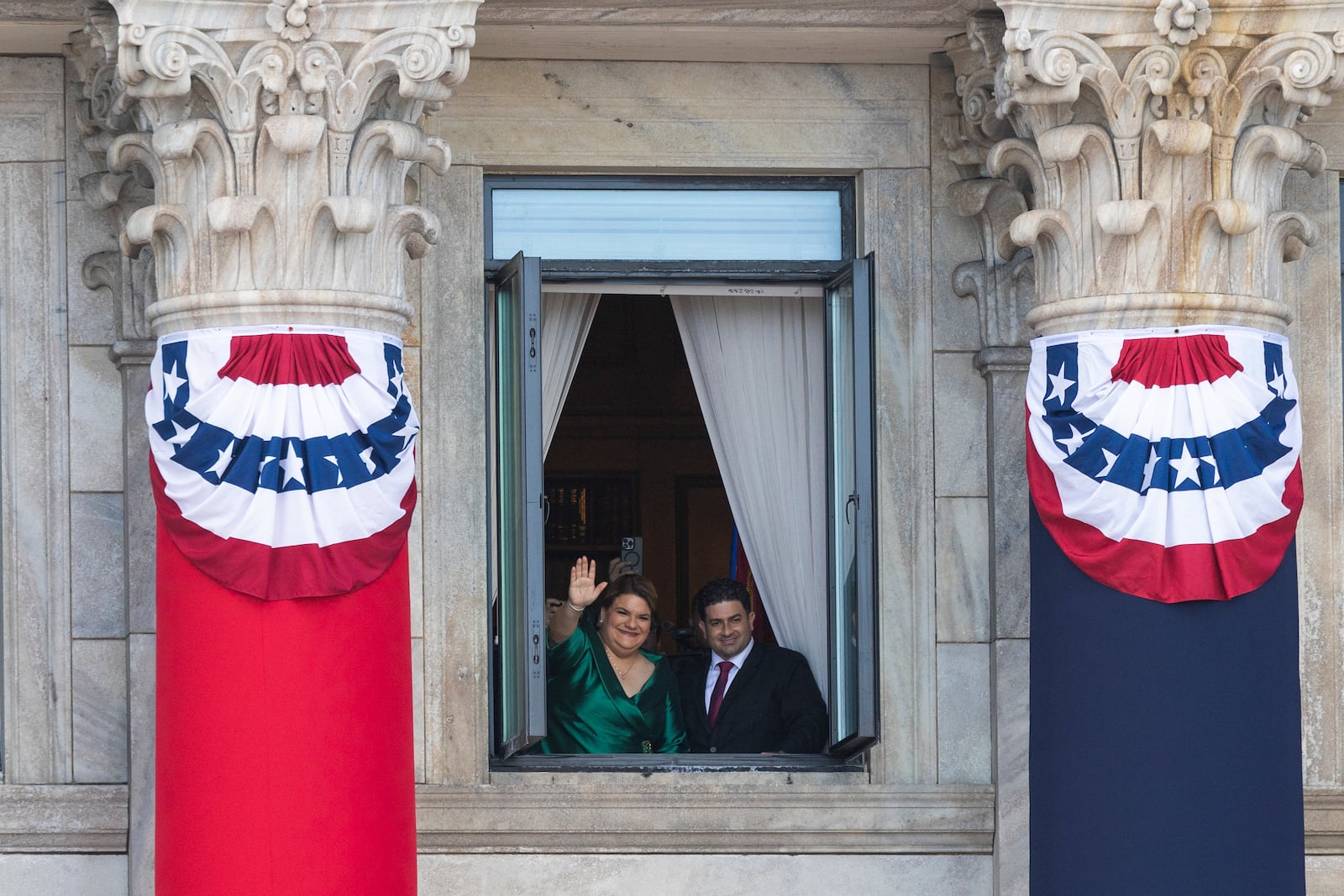 Jenniffer Gonzalez Colon waves next to her husband Jose Yovin Vargas, after her swearing-in ceremony as governor at the Capitol in San Juan, Puerto Rico, Thursday, Jan. 2, 2025. (AP Photo/Alejandro Granadillo)