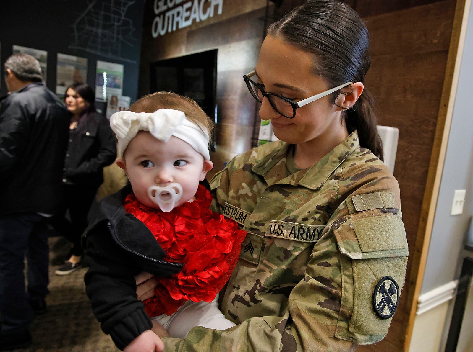 Sgt. Orchid Westrum spends some time with her niece, Avaia, during a Call to Duty Ceremony Friday, Jan. 12, at the First Christian Church. Westrum is being deployed with 30 other members of the Ohio National Guard's 1137th Signal Comapany, located in Springfield. BILL LACKEY/STAFF