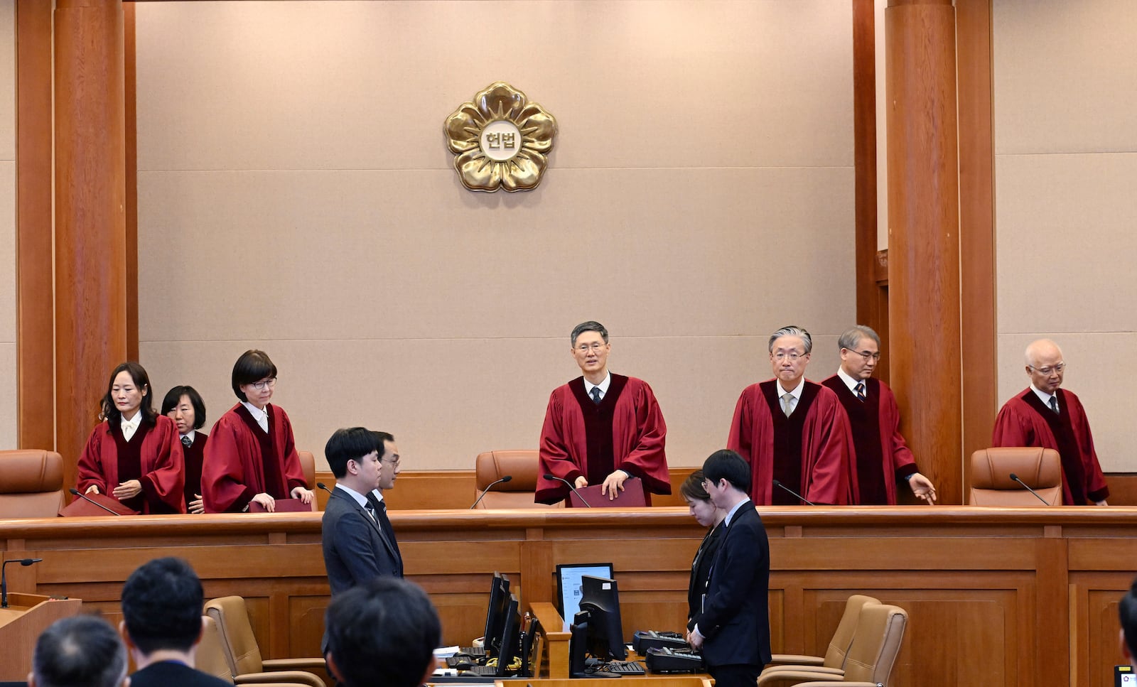 Moon Hyung-bae, fourth right, acting chief justice of South Korea's Constitutional Court, and other judges arrive for the impeachment verdict for South Korean Prime Minister Han Duck-soo at the Constitutional Court in Seoul Monday, March 24, 2025. (Kim Min-Hee/Pool Photo via AP)