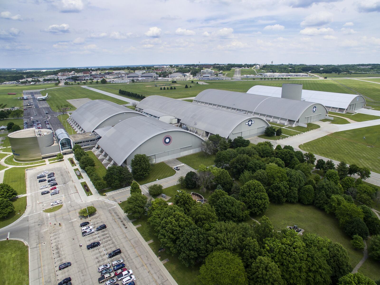 A previous aerial view of the National Museum of the U.S. Air Force. The museum collects, researches, conserves, interprets and presents the Air Force's history, heritage and traditions - as well as today's mission to fly, fight and win in Air, Space and Cyberspace - to a global audience through engaging exhibits, educational outreach, special programs, and the stewardship of the national historic collection. (U.S. Air Force photo by Jim Copes)