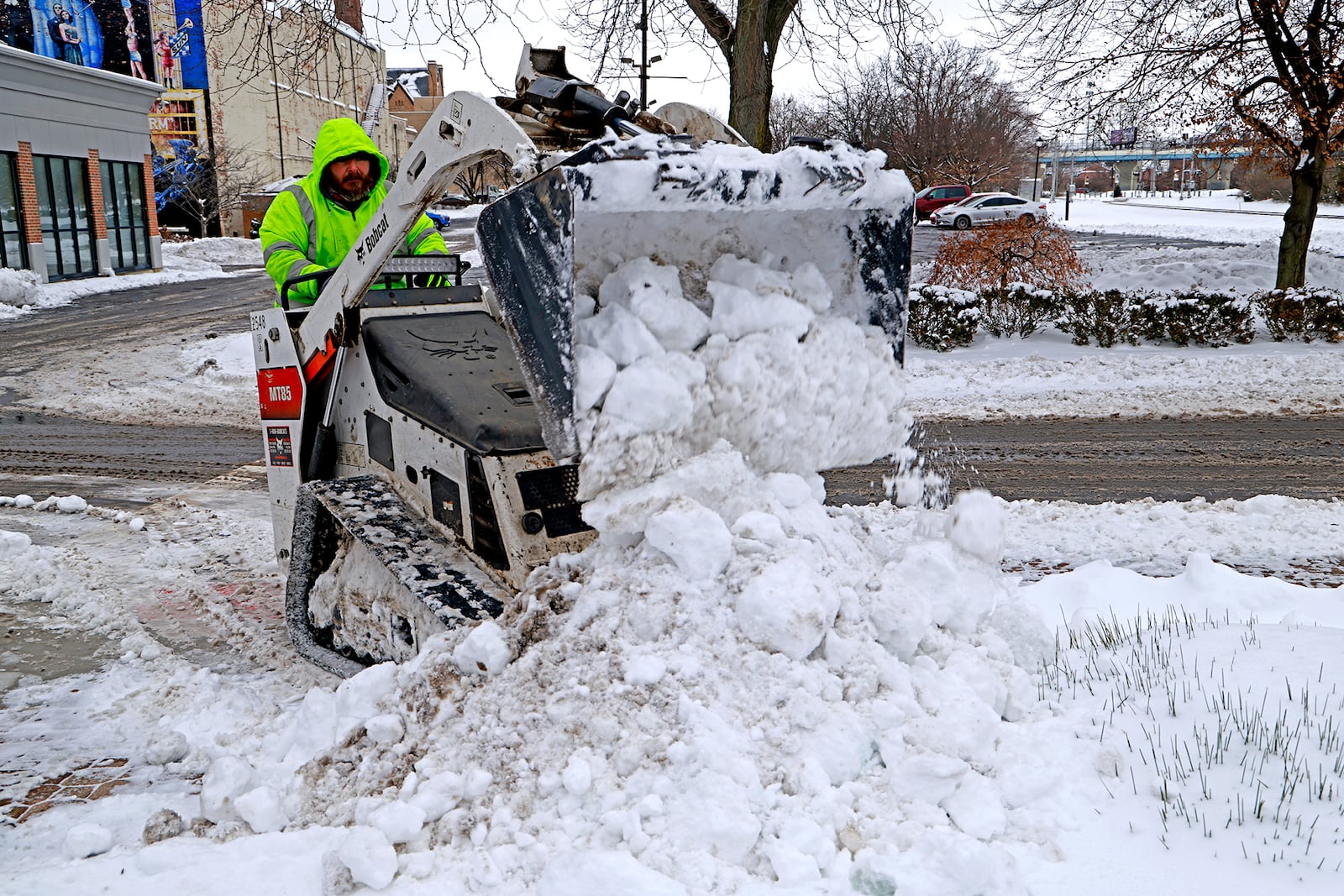 Mark Winget, from the City of Springfield Service Department, uses a small front end loader to clean off the sidewalks around the downtown Esplanade Tuesday, Jan. 7, 2025. BILL LACKEY/STAFF