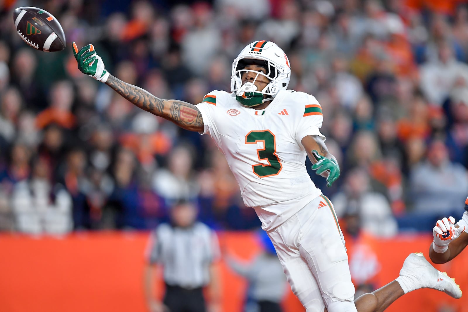 Miami wide receiver Jacolby George (3) reaches for a pass during the first half of an NCAA football game against Syracuse on Saturday, Nov. 30, 2024 in Syracuse, N.Y. (AP Photo/Adrian Kraus)