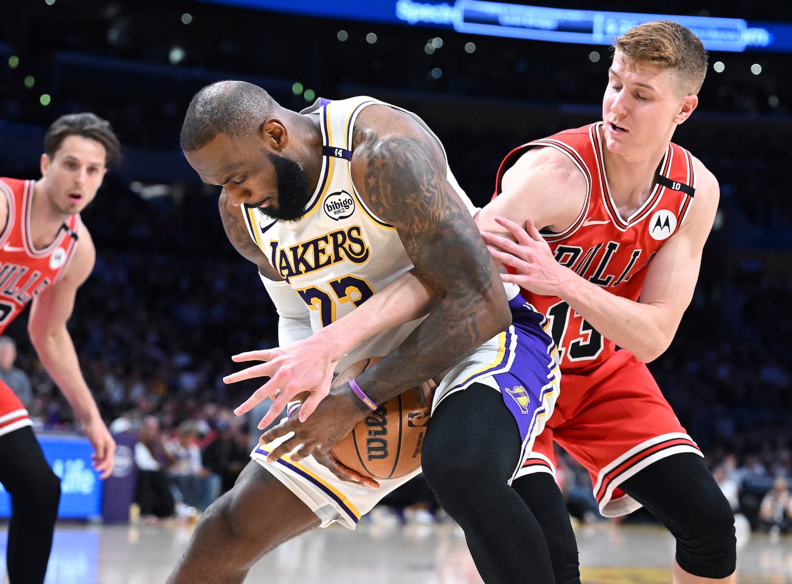 Chicago Bulls guard Kevin Huerter (13) tries to steal the ball away from Los Angeles Lakers forward LeBron James (23) in the second half of an NBA basketball game Saturday, March 22, 2025, in Los Angeles. (AP Photo/Wally Skalij)