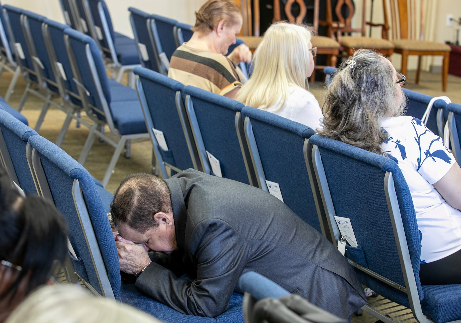 A congregant kneels in prayer at the Centro Cristiano El Pan de Vida, a mid-size Church of God of Prophecy congregation, in Kissimmee, Fla., Sunday, Feb. 2, 2025. (AP Photo/Alan Youngblood)