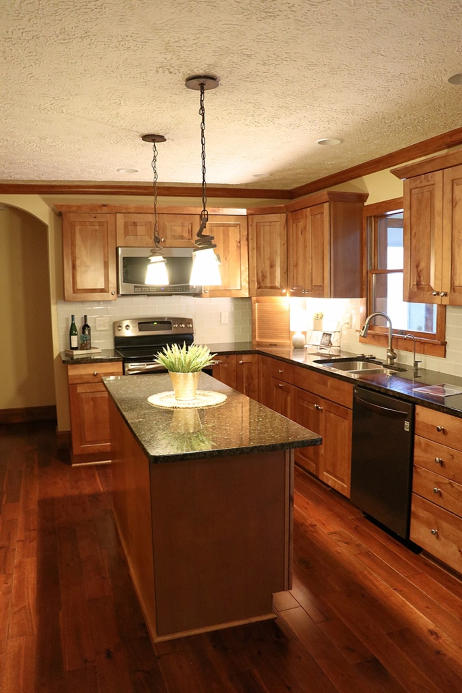 The kitchen has Shaker-style cabinetry with granite counters. 